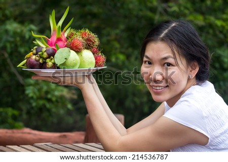 Woman holding fruit tray