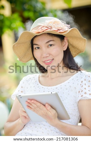 business woman using tablet computer doing work on her vacation
