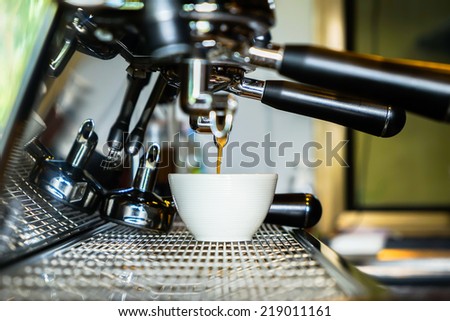 closeup making coffee in coffee machine at coffee shop