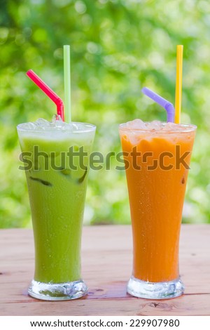Thai Ice Tea milk and green milk tea on green background