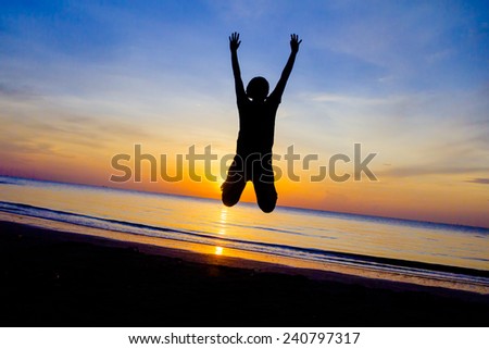 women jumping on the beach at sunset time