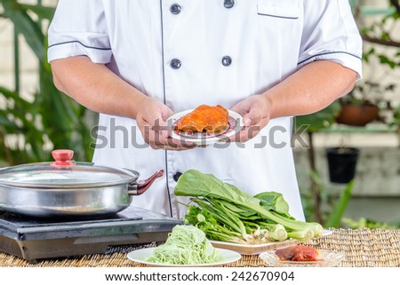 chef holding vegetable in kitchen