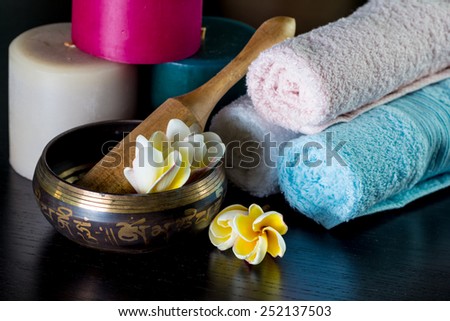 spa set with towel, candles, flower on wooden