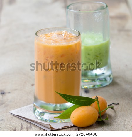 Ice green tea and milk tea in glass place on wooden