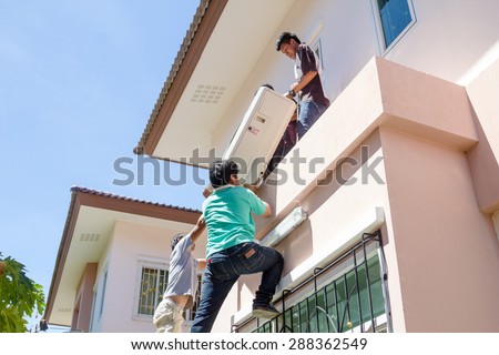 BANGKOK, THAILAND - JUNE 11 2015 : Air Conditioning Technician install air conditioner in house at bangkok thailand