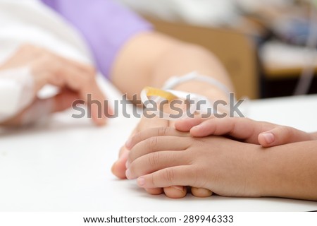 close up kid hands touch mom Hands of patients in hospital