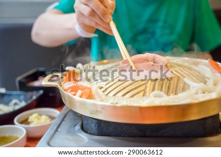 women eating BBQ or grilled pork for asian food