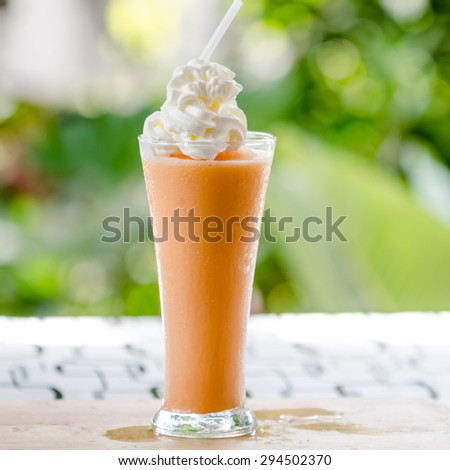 thai milk ice tea with cream on wooden table