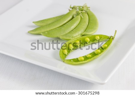 Freshly snow peas on wooden Cutting Board