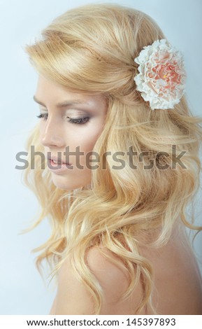portrait of the beautiful young girl in an image of the bride with ornament in hair