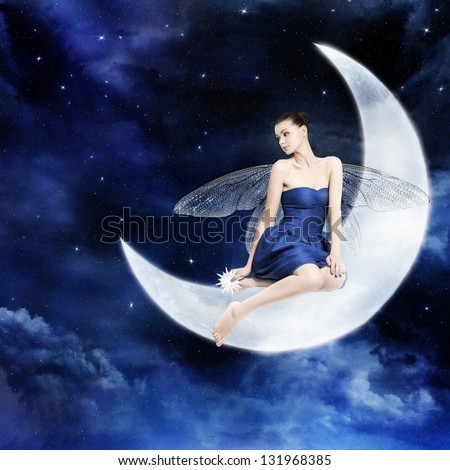 Gorgeous young woman as fairy sitting on the moon, night sky.