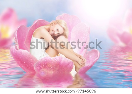 Young cute woman as thumbelina sitting in tulip Young cute woman as thumbelina sitting in tulip