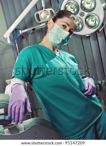 Young female doctor wearing mask in surgery
