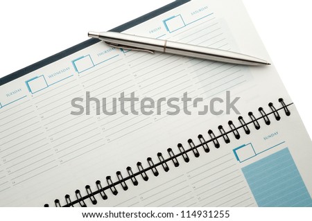 Open weekly planner showing hourly schedule with ball pen isolated on white.