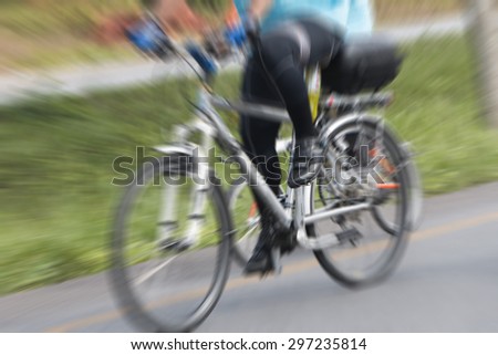 People riding bikes with motion blur.