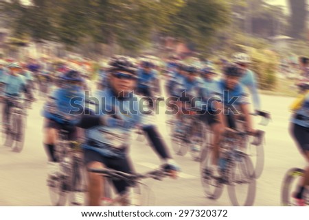 People riding bikes with motion blur.