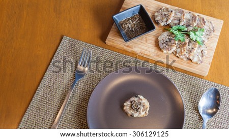 stuffed pork leg on dish served with sauce , Asian style food