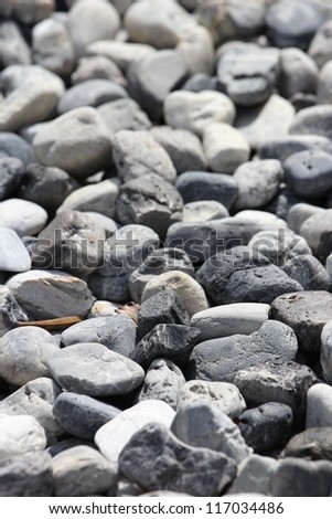 Naturally polished white rock pebbles background