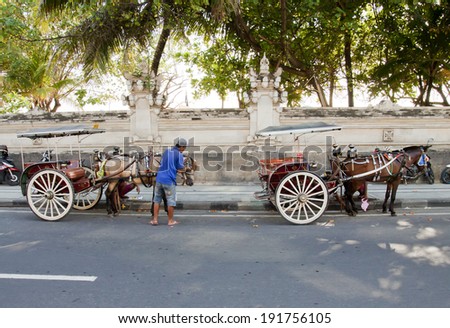BALI, INDONESIA - MARCH 15: Horse cart service in Kuta, Bali on March 15, 2014. Alternative public transport to explore Kuta town