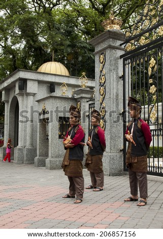 KUALA LUMPUR, MALAYSIA - FEBRUARY 17: Armed guards in traditional Malay costume stand at the entry gate of Royal Museum in Kuala Lumpur, Malaysia on February 17, 2013