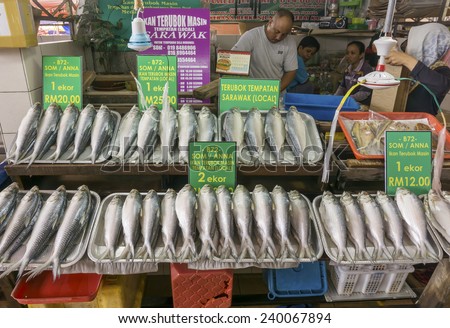 KUCHING, MALAYSIA - NOV 9:Fish vendor selling salted Terubok at the Satok Wet Market in Kuching, Sarawak on Nov 9, 2014. Terubok(Tenualosa toli) is highly prized among Malaysians for its meat and eggs