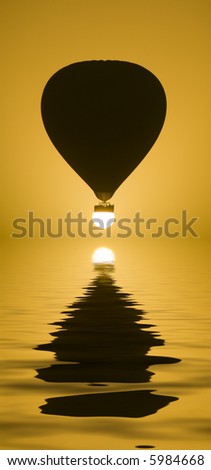 A Hot Air Balloon perfectly aligned with the sun. (with water reflection)