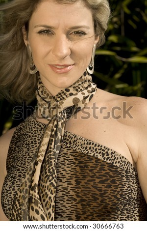 A very pretty and young blond brazilian woman wearing a leopard skin like blouse.