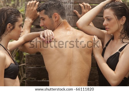 stock photo Two young girls and a handsome man taking a shower at the