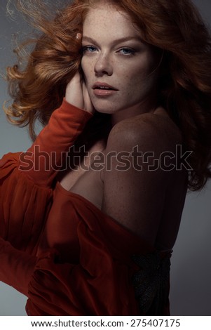 Close-up portrait of young, beautiful and healthy woman with arrows on her face.Redhead
