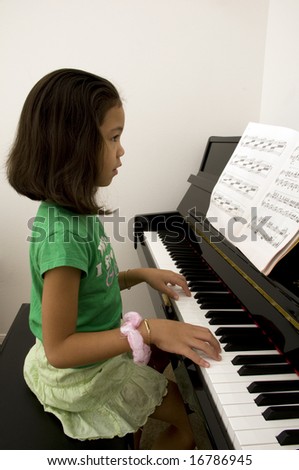 Asian Girl Playing the Piano