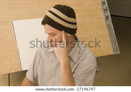 Man Thinking at Drawing Desk