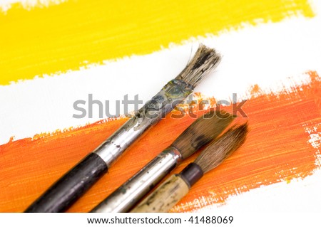 Brushes on Yellow and Orange Paint