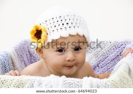 Cute Baby in Crochet Hat with Expressive Face.