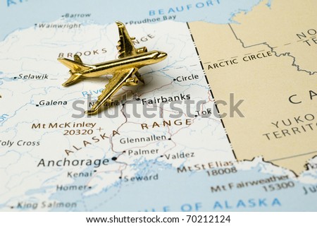 Golden Plane Over Map of Alaska. Map is Copyright Free Off a Government Website.