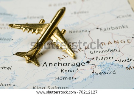 Golden Plane Over Map of Alaska. Map is Copyright Free Off a Government Website.