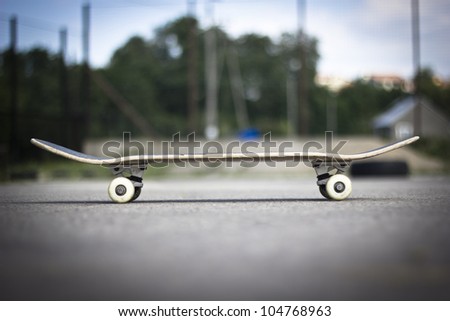 Skateboard deck on the asphalt ground.