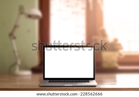 Laptop with blank screen on table