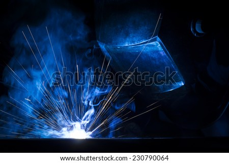 Employee welding using MIG/MAG welder.
