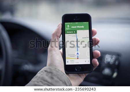 KRAKOW, POLAND - DECEMBER 25, 2014: Google navigation app leading to direction point on apple iphone 5s most famous smartphone in the world.