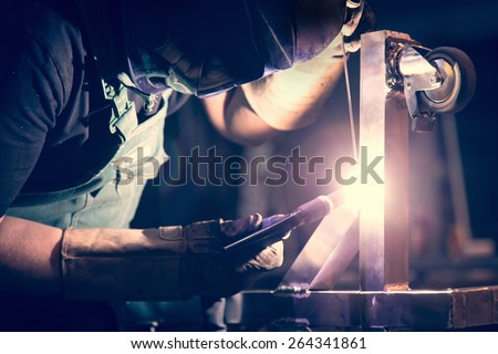 Worker welding aluminum using tig welder
