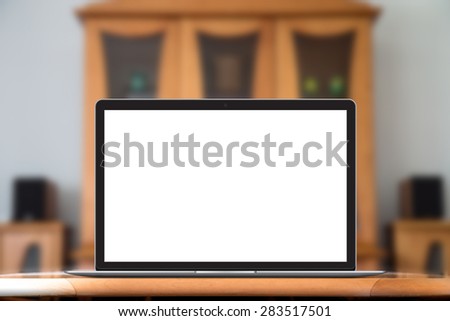 Laptop with blank screen on table in livingroom