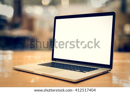 Laptop with blank screen on table.