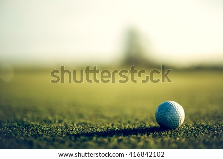 Grunge golf ball on course