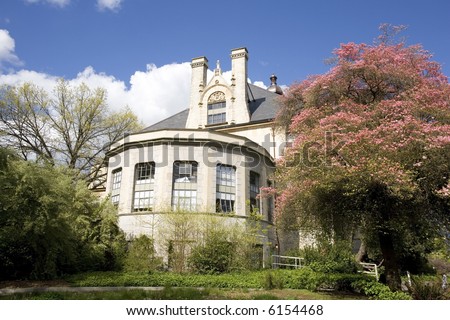 Academic building surrounded by blossoming trees in spring