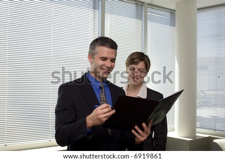 Two business people in an office in a meeting