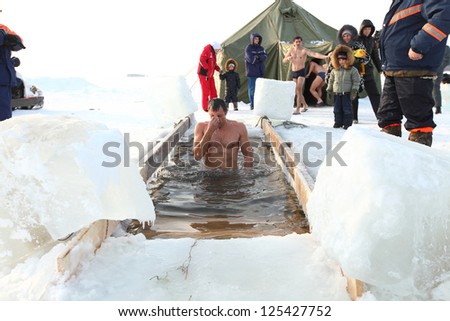 MOSCOW, RUSSIA - JANUARY 19: Swimming in the ice-hole, celebration of Epiphany (Holy Baptism)  in the Orthodox tradition, January 19, 2013 in Moscow, Russia.