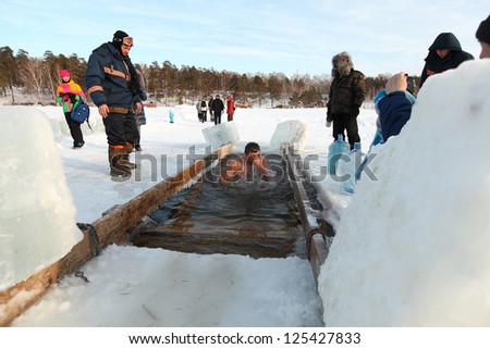 MOSCOW, RUSSIA - JANUARY 19: Swimming in the ice-hole, celebration of Epiphany (Holy Baptism)  in the Orthodox tradition, January 19, 2013 in Moscow, Russia.