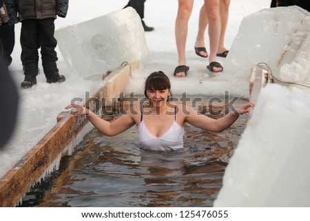 Moscow, RUSSIA - JANUARY 19: Swimming in the ice-hole, celebration of Epiphany (Holy Baptism)  in the Orthodox tradition, January 19, 2013 in Moscow, Russia.