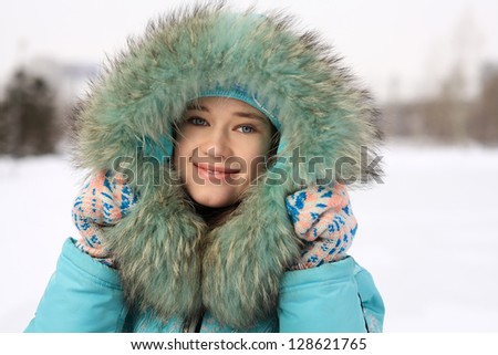 Young girl skating on the frozen lake (Young woman skating on ice with figure skates outdoors in the snow)