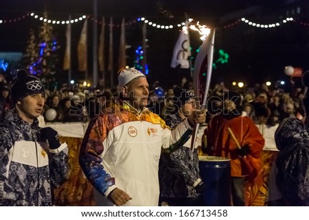 Novosibirsk, Russia - December 7, 2013 :Karelin, Alexander with the Olympic torch at the Olympic torch relay in Novosibirsk